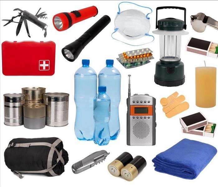 Flashlight, portable radio, batteries, water bottles and a first aid kit